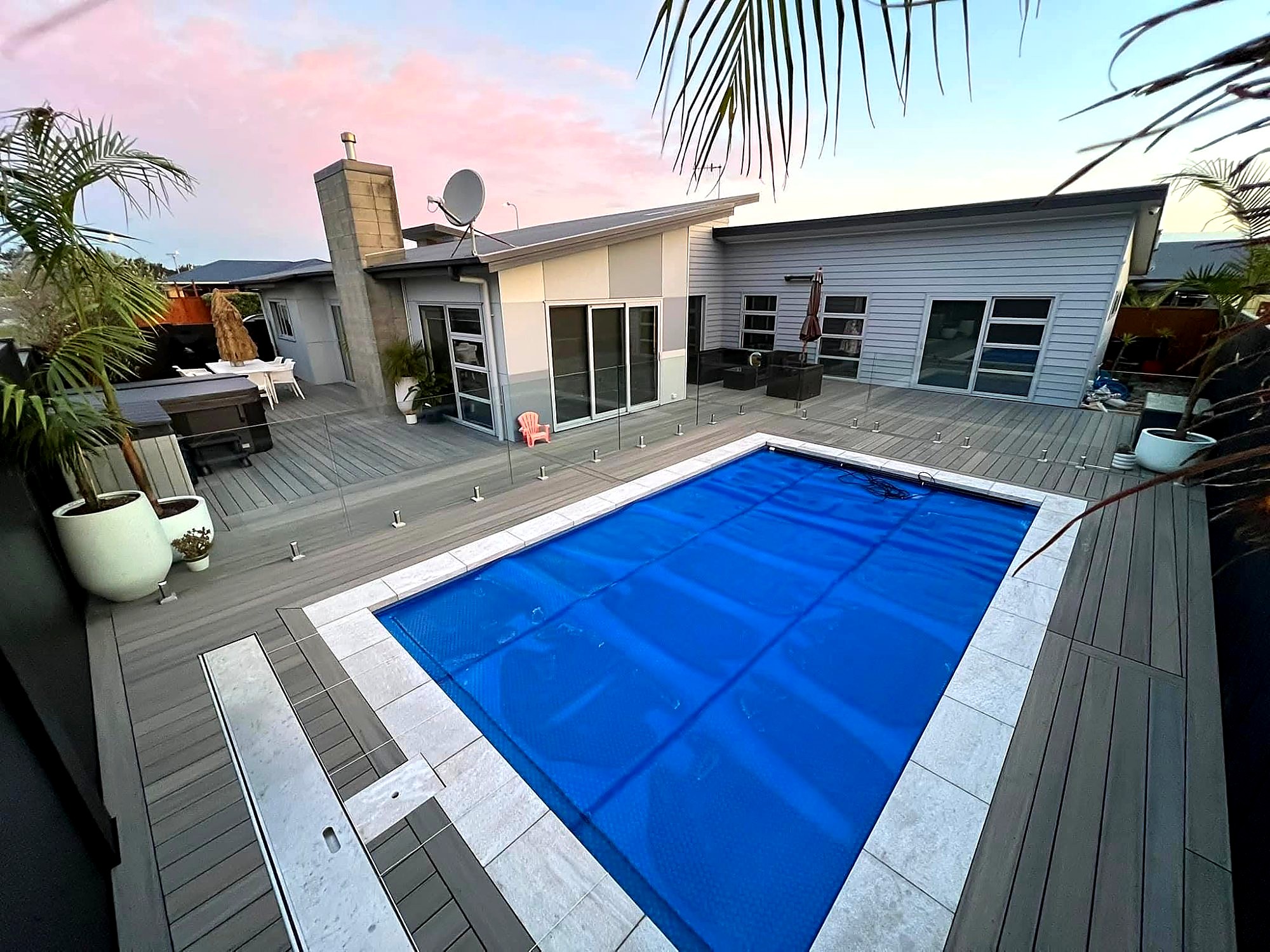 Composite deck with spa and glass balustrade at sunset, Foxton Beach